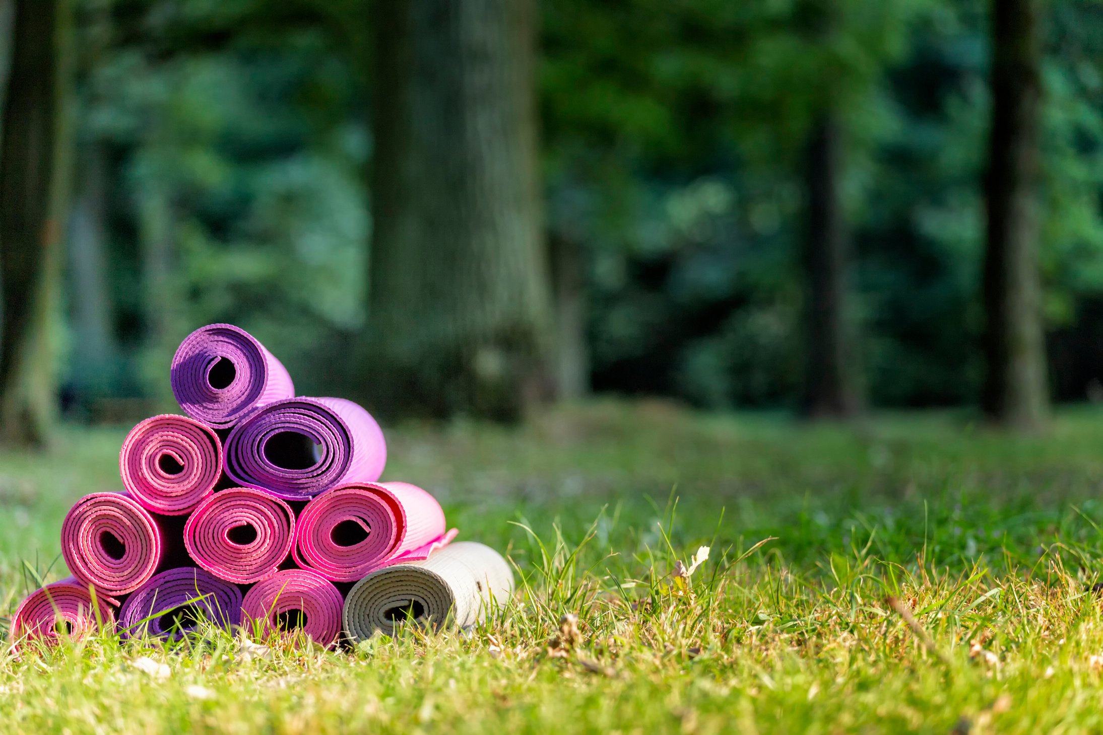 colorful yoga mats, green background